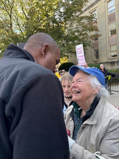Profile picture of NY Lieiutenant Governor Antonio Delgado talking to a smiling older woman. 